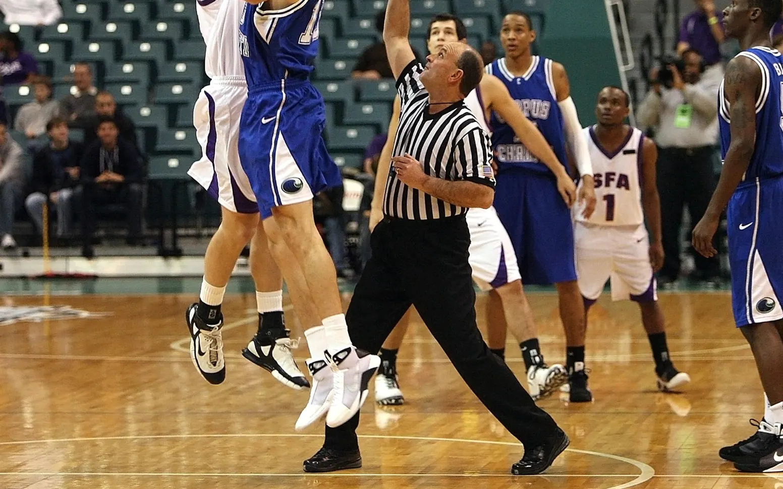 Basketball, jump ball and referee